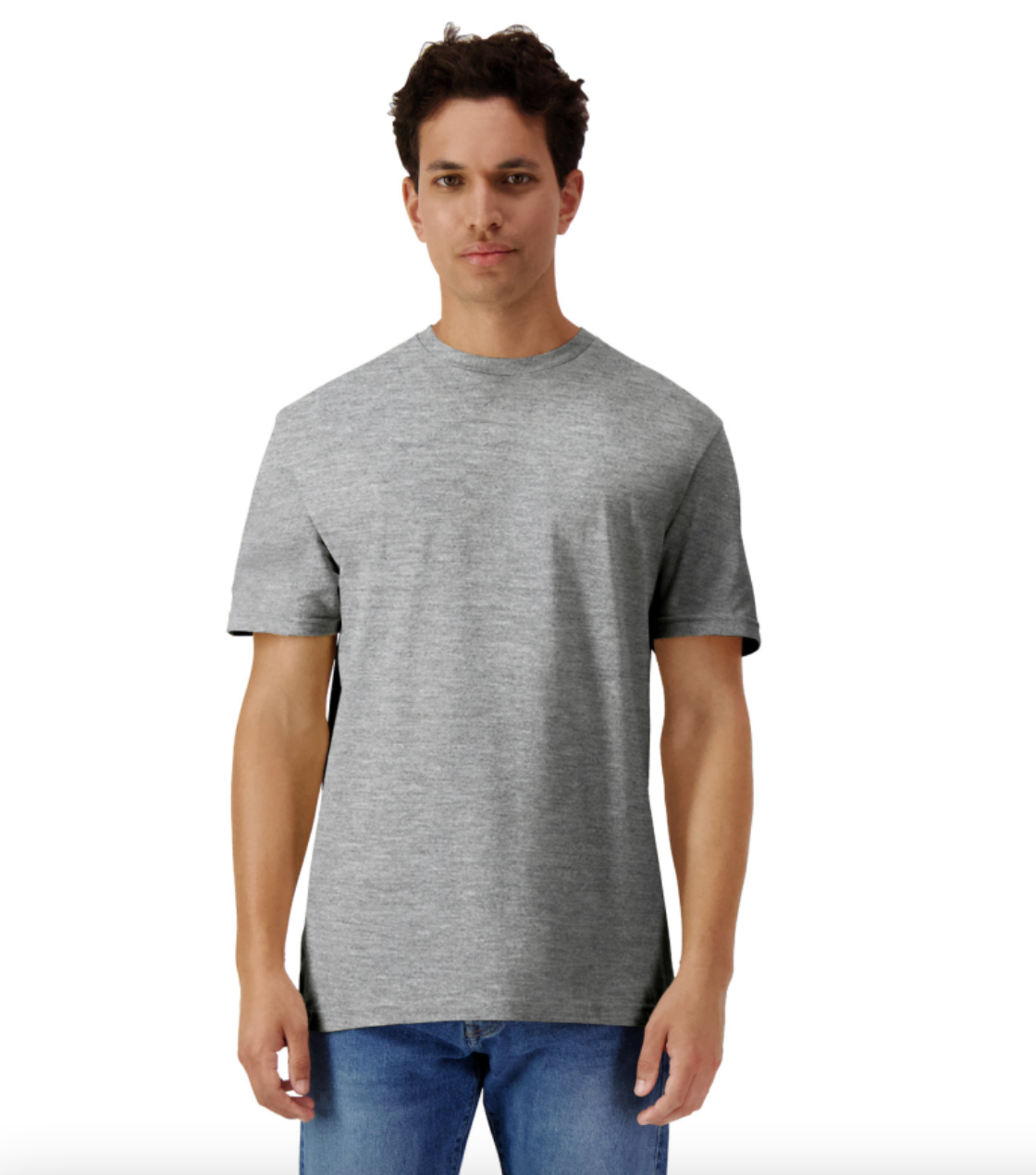 Man wearing a gray t-shirt and blue jeans on a white background
