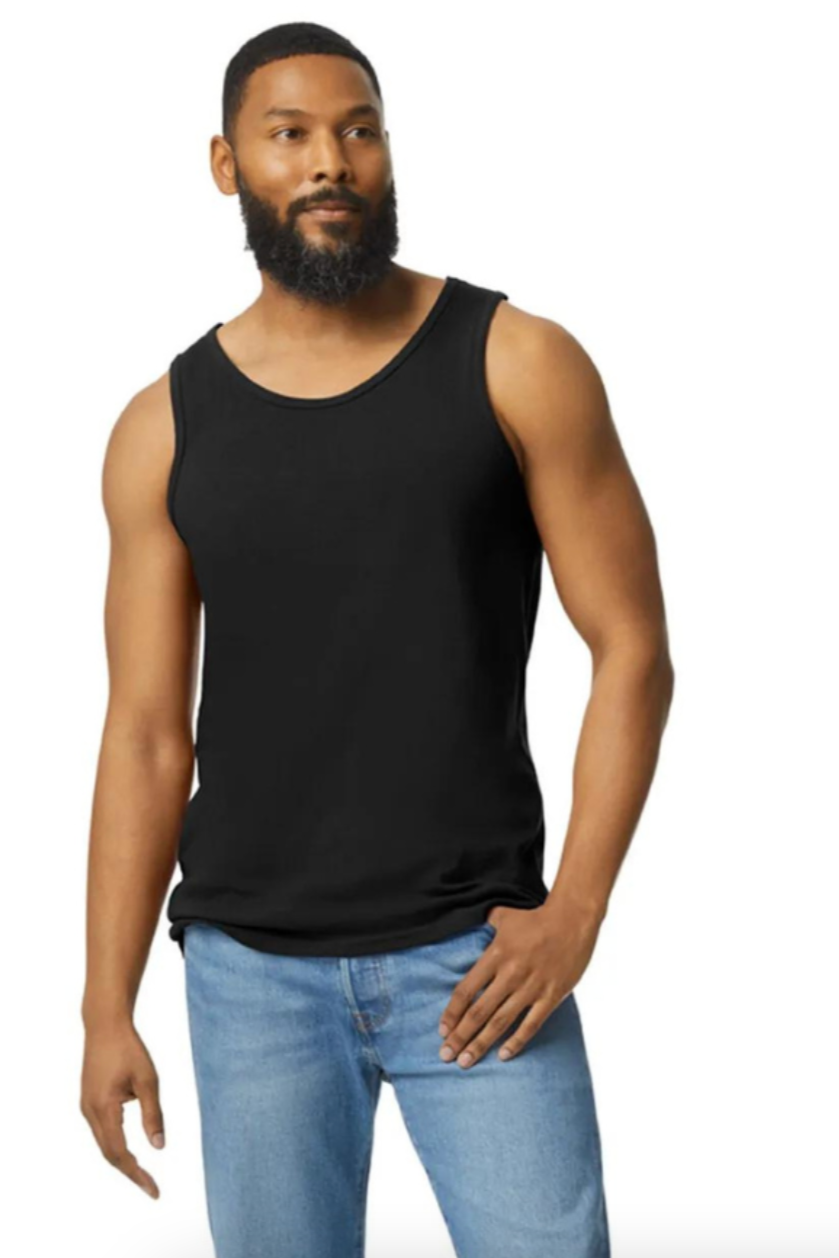 Man wearing a black tank top and light blue jeans on a white background