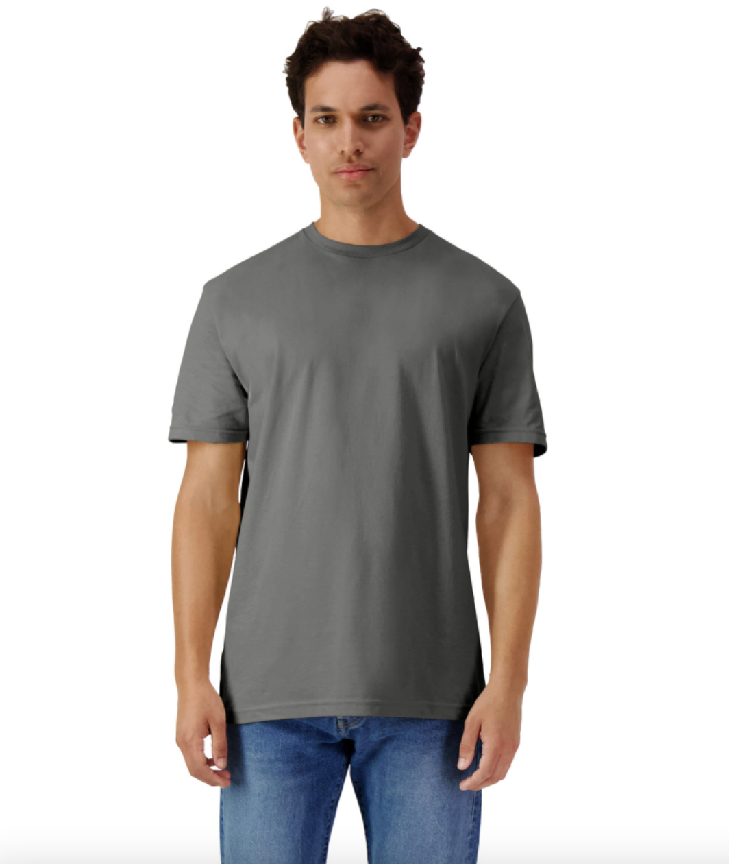 Man wearing a gray t-shirt and blue jeans on a white background