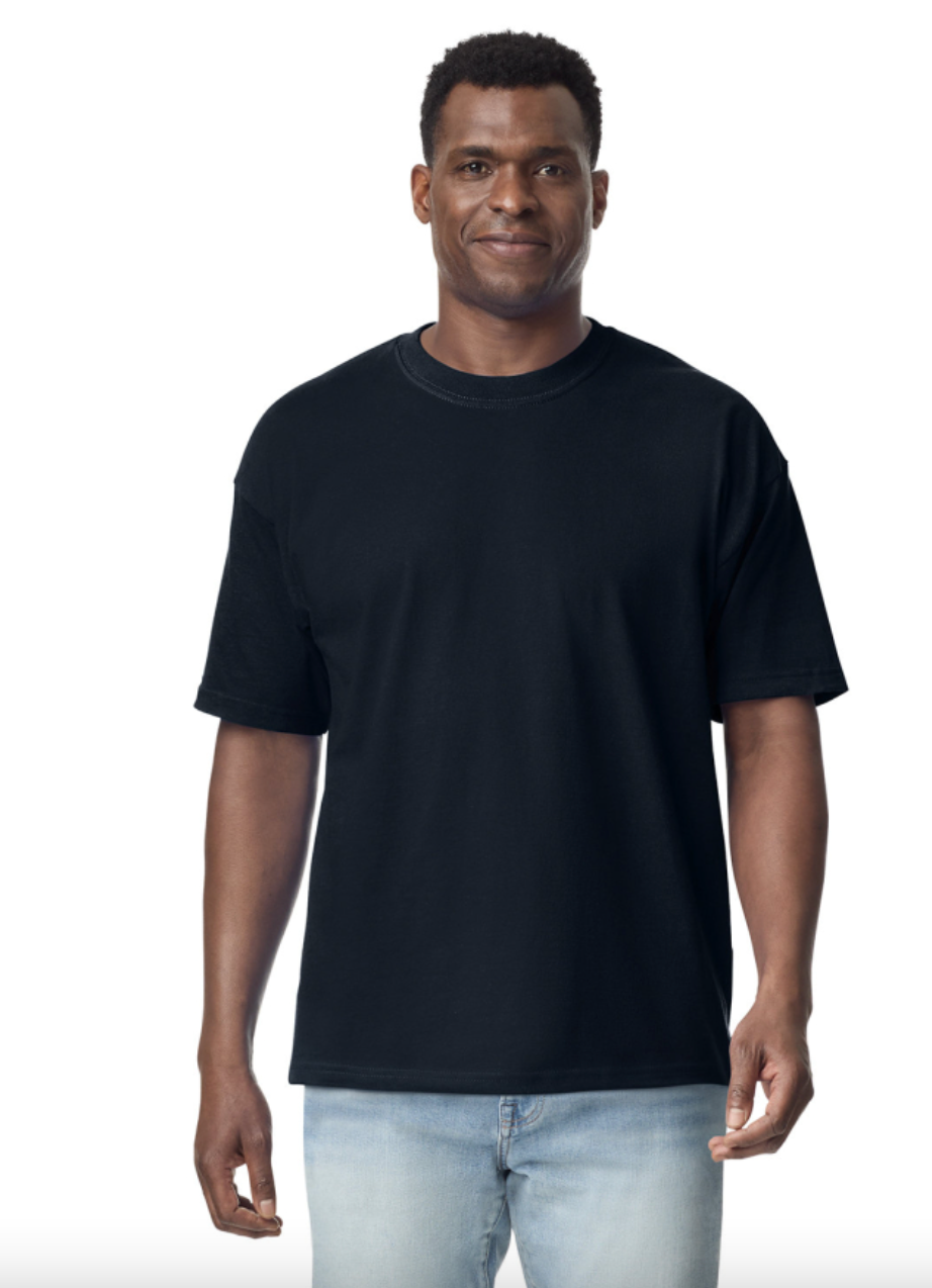Man wearing a black t-shirt and light blue jeans on a white background