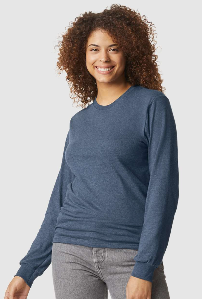Woman wearing a blue long-sleeve shirt and gray pants on a light gray background