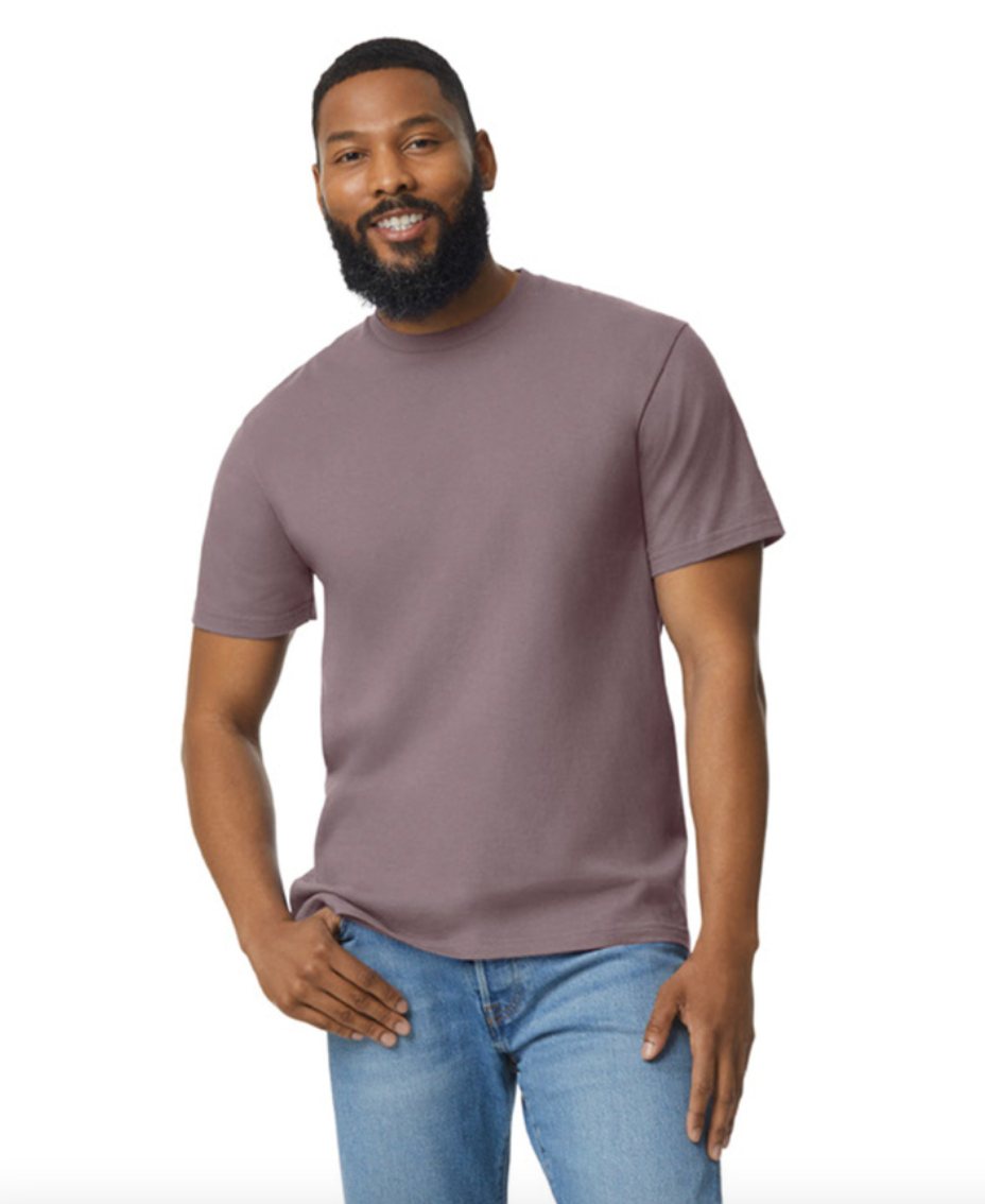 Man wearing a plain purple t-shirt and blue jeans on a white background
