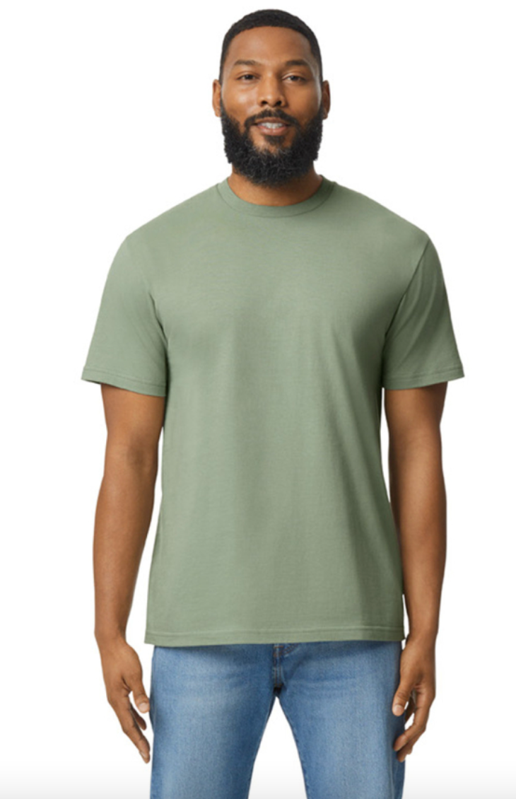 Man wearing a green t-shirt and blue jeans on a white background
