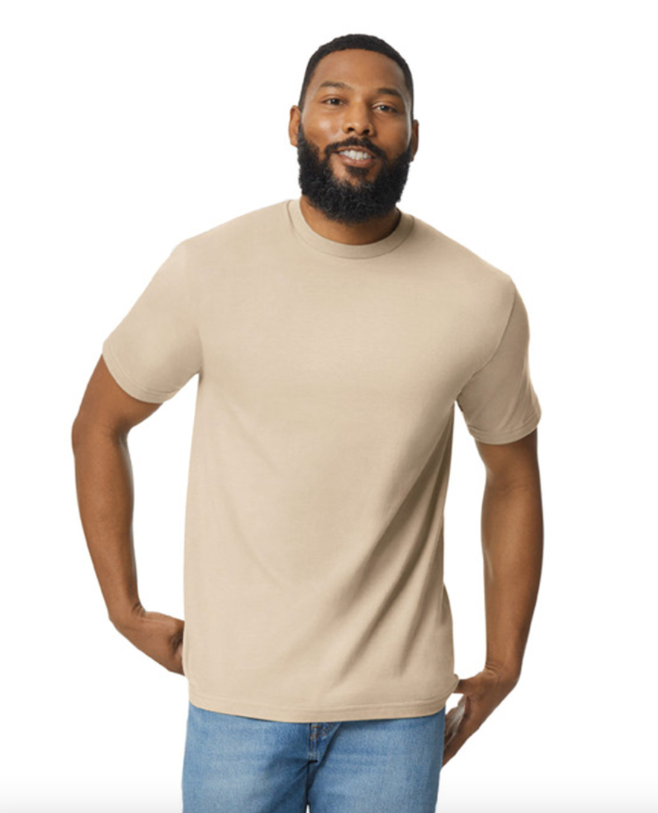 Man wearing a beige t-shirt and blue jeans on a white background