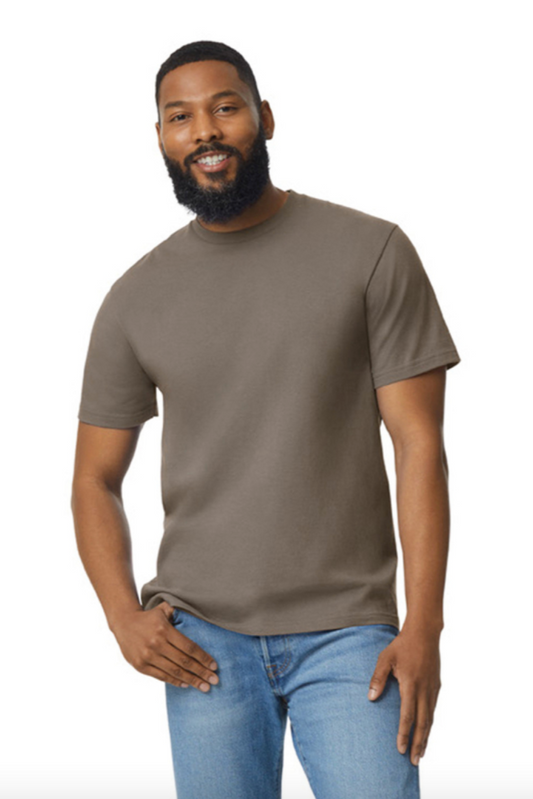 Man wearing a brown t-shirt and blue jeans on a white background