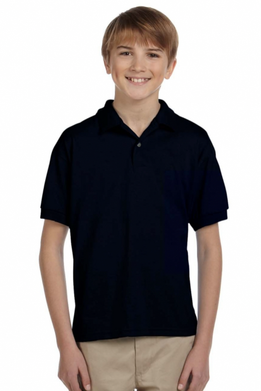 Young boy wearing a black polo shirt and beige pants on a white background