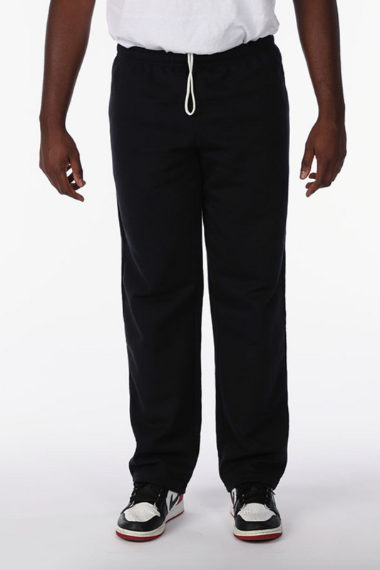 Person wearing black pants on a white background